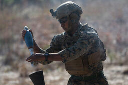 U.S. Marine loads a round