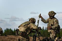 Soldiers load mortar
