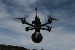 Still frame from Fiber-Optic Tether products video, flying drone with tether pack
