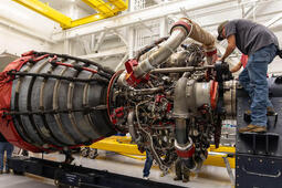 Employees work on an RS-25 engine