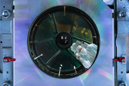 Engineer inspects NASA's Nancy Grace Roman Space Telescope's primary mirror at the L3Harris facility in Rochester, New York. Credit: NASA