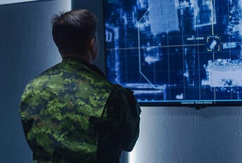 U.S. soldier observing topographical data on a computer monitor. Image source: Shutterstock https://www.shutterstock.com/license