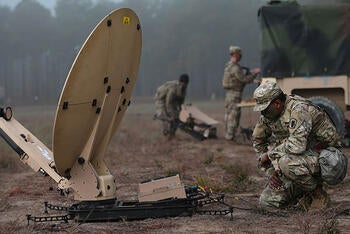 Soldier with VSAT SATCOM terminal in the field