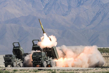 Rocket launches from launcher with mountains in background