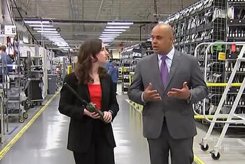 Communication Systems President Sam Mehta gets interviewed at a facility by a reporter