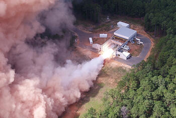 Rocket motor test fires in a forest