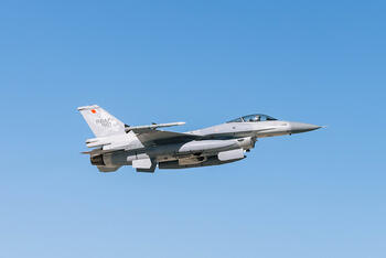 Jet soars through blue sky