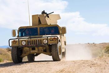 humvee with soldiers in desert