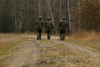 German soldiers patrol through woods