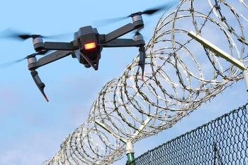 enemy drone hovering over fence