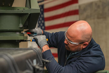 An L3Harris employee works on the company's new high-volume production line for VAMPIRE™