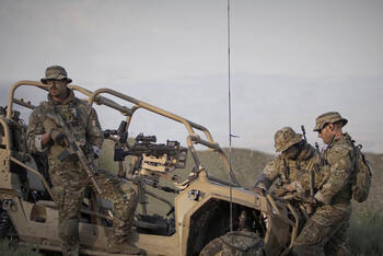 Soldiers near vehicle using HF radio