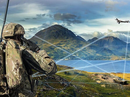 Soldier looks at battlefield with assets linked on network