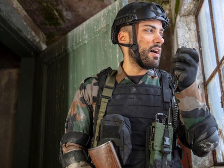 Soldier speaks into radio