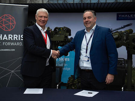 Executives from L3Harris and Thales UK shake hands