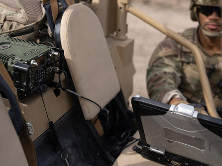Soldier using laptop with NGC2 at mobile TOC