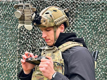 Soldier inspects his devices