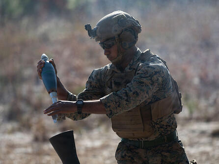 U.S. Marine loads a round