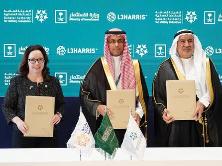 Leaders at the World Defense Show sign letters