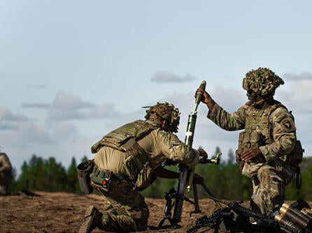 Soldiers load mortar