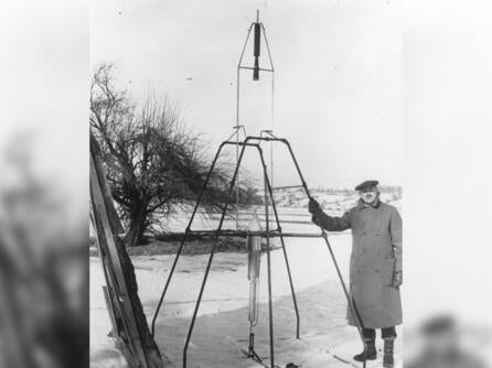Dr. Robert H. Goddard and a liquid oxygen-gasoline rocket in the frame from which it was fired on March 16, 1926, at Auburn, Massachusetts. Credit: NASA