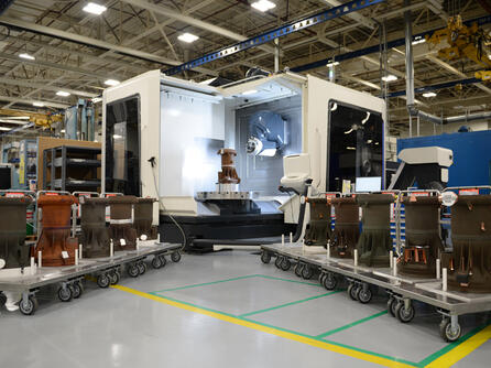 3D printed RL10 rocket engine combustion chambers shown in the manufacturing area at L3Harris’ facility in West Palm Beach, Florida.