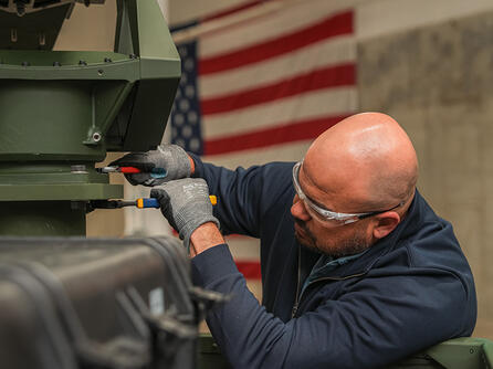 An L3Harris employee works on the company's new high-volume production line for VAMPIRE™