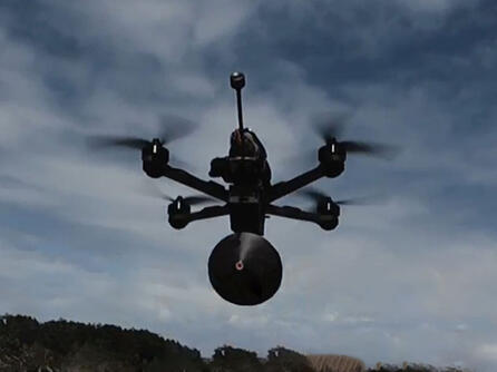 Still frame from Fiber-Optic Tether products video, flying drone with tether pack