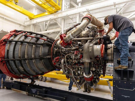 Employees work on an RS-25 engine
