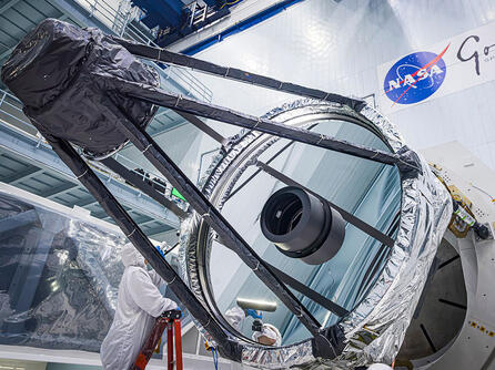 Optical Engineer Bente Eegholm performs and inspection of Roman's Primary mirror. This was taken shortly after it was lifted out of the shipping container. Credit: NASA/Chris Gunn.