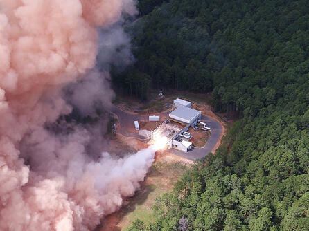 A solid rocket motor test fires at a facility