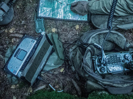 Pieces of military communications devices lie on the ground