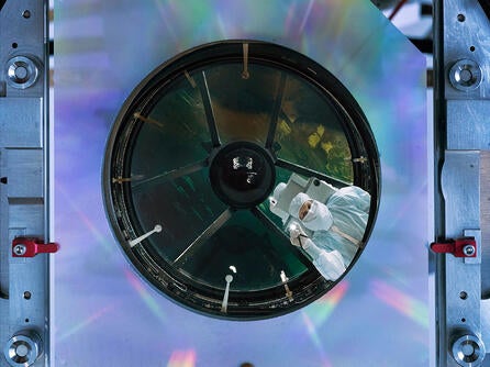 Engineer inspects NASA's Nancy Grace Roman Space Telescope's primary mirror at the L3Harris facility in Rochester, New York. Credit: NASA