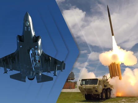 A jet flies through the air and a missile launches from a ground launcher