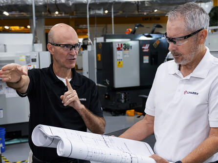Greg Burns, Director of Operations, L3Harris Canoga Park Site (L) and Pat O’Kelley, L3Harris Canoga Park Site Lead (R), discuss expansion plans.