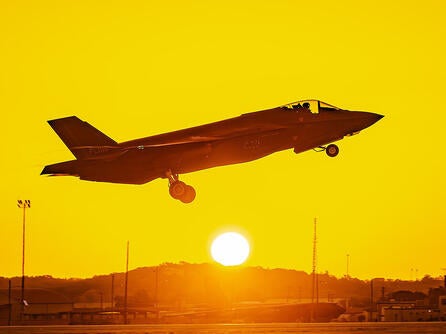 F-35 takes off from tarmac at sunrise