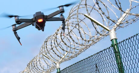 enemy drone hovering over fence