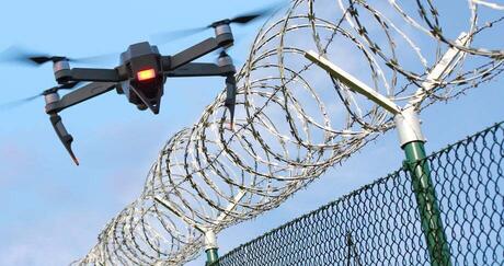 enemy drone hovering over fence