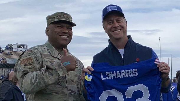L3Harris and US Air Force soldiers celebrating falcon football game