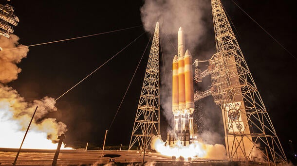 A rocker readies to launch beneath a black sky