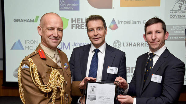 Three people hold award designation