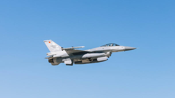 Jet soars through blue sky