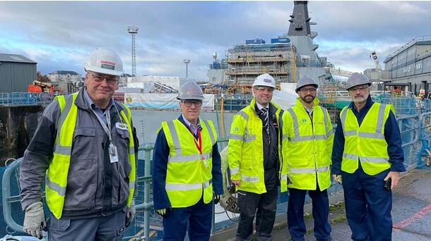 L3Harris team members stand on a dock