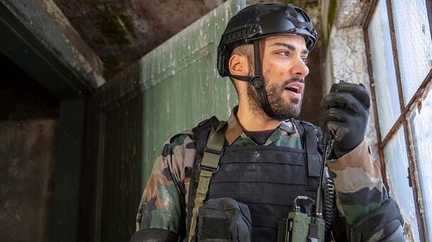 Soldier speaks into radio