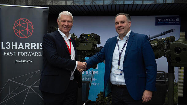 Executives from L3Harris and Thales UK shake hands