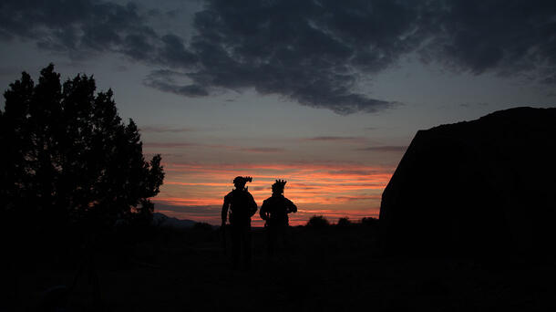 Soldiers wearing helmet-mounted night vision at dusk