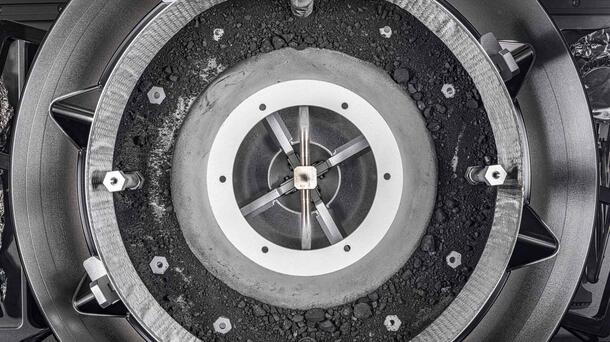 A top-down view of the OSIRIS-REx sample container with the lid removed, revealing the remainder of the asteroid sample inside. Photo: NASA/Erika Blumenfeld &amp; Joseph Aebersold