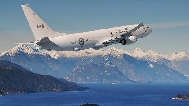 P-8A flies over mountain range
