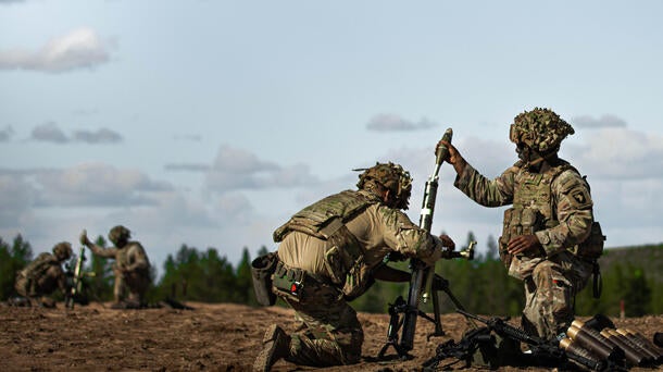 Soldiers load mortar