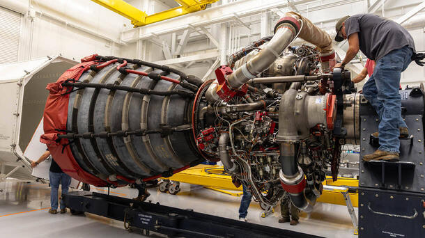 Employees work on an RS-25 engine